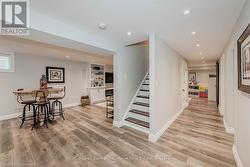 Staircase featuring recessed lighting, wood finished floors, and baseboards - 