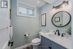 Bathroom featuring vanity, toilet, and baseboards - 