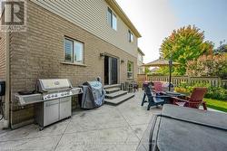 View of patio / terrace with entry steps, a fire pit, a grill, and fence - 