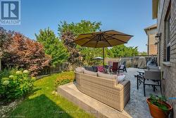 View of patio featuring outdoor dining space, outdoor lounge area, and a fenced backyard - 