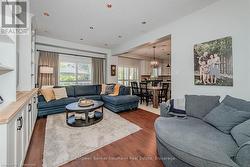 Living area with dark wood-style floors and a textured ceiling - 