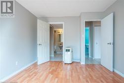 Unfurnished bedroom featuring light wood-type flooring, baseboards, and connected bathroom - 