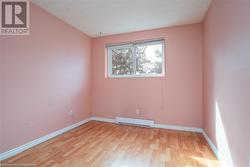 Spare room featuring light wood finished floors, a baseboard radiator, and baseboards - 