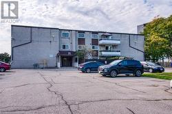 View of building exterior with uncovered parking - 