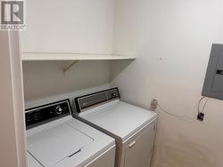 Laundry room in suite with washer and dryer. - 