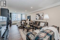 Living room featuring recessed lighting, a textured ceiling, baseboard heating, and wood finished floors - 