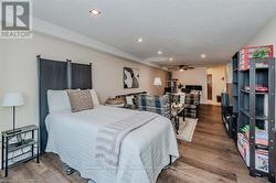 Bedroom featuring recessed lighting, a textured ceiling, and wood finished floors - 