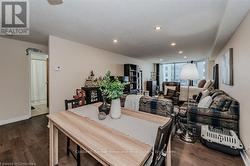 Dining room featuring a textured ceiling, wood finished floors, and recessed lighting - 