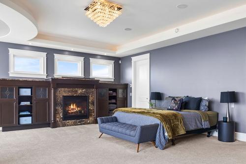 4040 Casorso Road, Kelowna, BC - Indoor Photo Showing Bedroom With Fireplace
