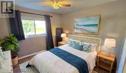 Bedroom with ceiling fan, wood finished floors, and baseboards Virtual Staged - 