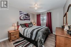 Bedroom with ceiling fan and light hardwood / wood-style flooring - 