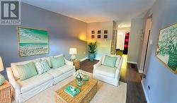 Living area with wood finished floors and baseboards Virtual Staged - 