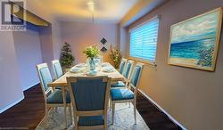 Dining room featuring baseboards and wood finished floors Virtual Staged - 