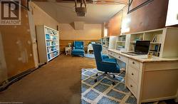 Office area featuring a garage and carpet floors Virtual Staged - 