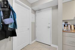 Tiled foyer. Coat rack inside door to the left. - 