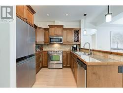 Beautiful kitchen with granite tile counters, eating bar, stainless steel appliances (newer fridge) - 