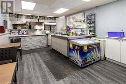 Kitchen featuring wood finished floors and a paneled ceiling - 