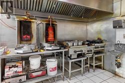 Kitchen featuring tile patterned flooring, tasteful backsplash, and a sink - 