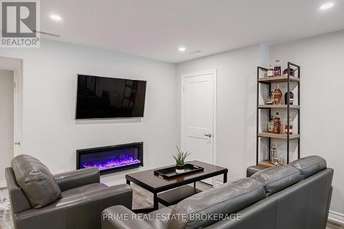 Lower level living room 3 w/ electric fireplace - 855 Oakcrossing Road, London, ON - Indoor Photo Showing Living Room With Fireplace