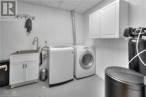 Laundry room featuring a sink, cabinet space, and washer and dryer - 42 Culpepper Drive, Waterloo, ON - Indoor Photo Showing Laundry Room