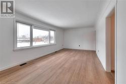 Unfurnished room with light wood-style flooring and baseboards - 