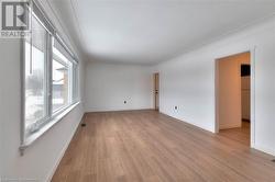 Unfurnished room with light wood finished floors and baseboards - 