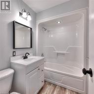 Full bathroom with toilet, shower / bath combination, wood finished floors, and vanity - 