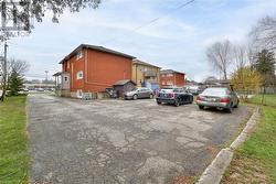 View of property exterior featuring brick siding and fence - 