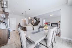 Dining area featuring stairs, recessed lighting, and baseboards - 