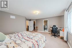 Bedroom featuring visible vents, light colored carpet, and baseboards - 