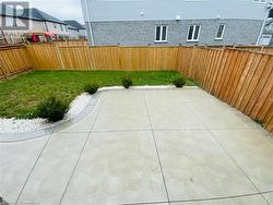 View of patio with a fenced backyard - 