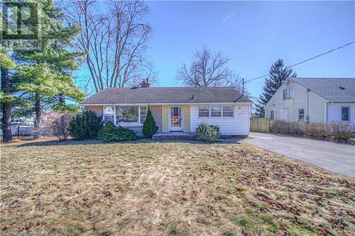 Ranch-style house featuring a chimney, a front lawn, and fence - 153 Ballantyne Avenue, Cambridge, ON - Outdoor