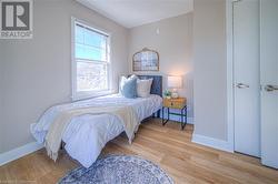 Bedroom featuring light wood-style flooring and baseboards - 