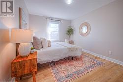 Bedroom featuring wood finished floors and baseboards - 