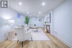 Living area featuring recessed lighting, visible vents, baseboards, and light wood-style floors - 