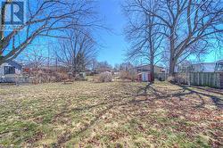 View of yard with a shed, an outdoor structure, and fence - 