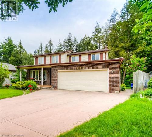 View of front of house featuring brick siding, driveway, a porch, and a garage - 105 Sabrina Crescent, Kitchener, ON - Outdoor