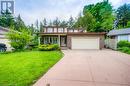 View of front of house with fence, a front lawn, concrete driveway, a garage, and brick siding - 105 Sabrina Crescent, Kitchener, ON  - Outdoor With Facade 