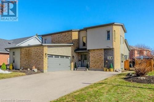 View of front of house featuring concrete driveway, brick siding, and a garage - 598 Coppercroft Court, Waterloo, ON - Outdoor