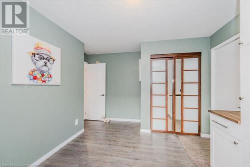 Laundry room with baseboards and light wood-style floors - 598 Coppercroft Court, Waterloo, ON - Indoor Photo Showing Other Room