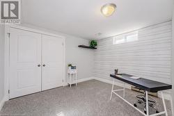 Unfurnished office featuring baseboards and wood walls - 