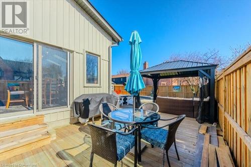 Wooden terrace featuring a gazebo, outdoor dining area, a grill, and a fenced backyard - 598 Coppercroft Court, Waterloo, ON - Outdoor With Deck Patio Veranda With Exterior