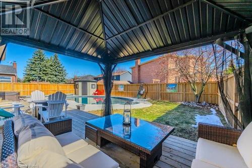 Wooden deck featuring an outbuilding, a fenced in pool, an outdoor living space, a fenced backyard, and a storage unit - 598 Coppercroft Court, Waterloo, ON - Outdoor With Deck Patio Veranda With Exterior