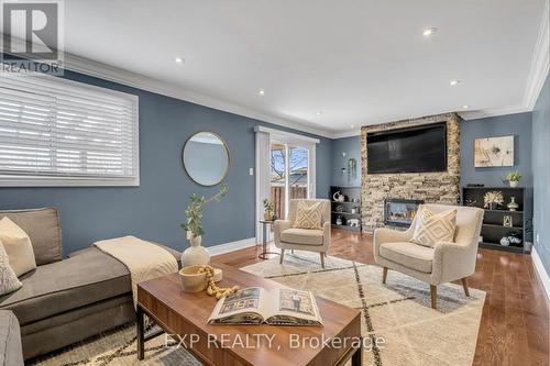 Lower Level Family Room W/O to Yard - 935 Lovingston Crescent, Mississauga, ON - Indoor Photo Showing Living Room With Fireplace