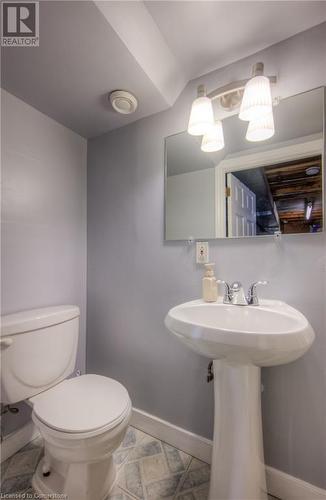 Bathroom featuring toilet, baseboards, and a sink - 55 Ingleside Drive, Kitchener, ON - Indoor Photo Showing Bathroom