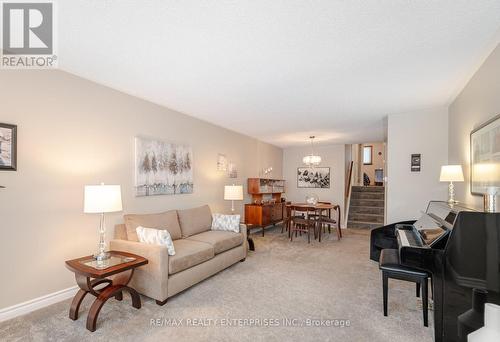 The broadloom covers a beautiful classic hardwood - 2000 Silverberry Crescent, Mississauga, ON - Indoor Photo Showing Living Room