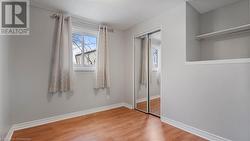 Unfurnished bedroom with a closet, visible vents, light wood-style flooring, and baseboards - 