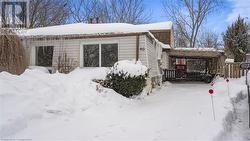 View of snow covered exterior with a carport - 