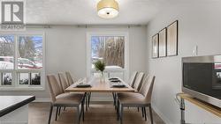 Dining room featuring baseboards and wood finished floors - 