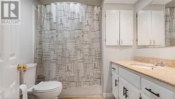 Full bath with toilet, tile patterned flooring, and vanity - 